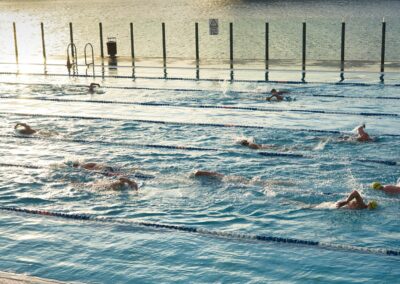 a group of people swimming in a pool